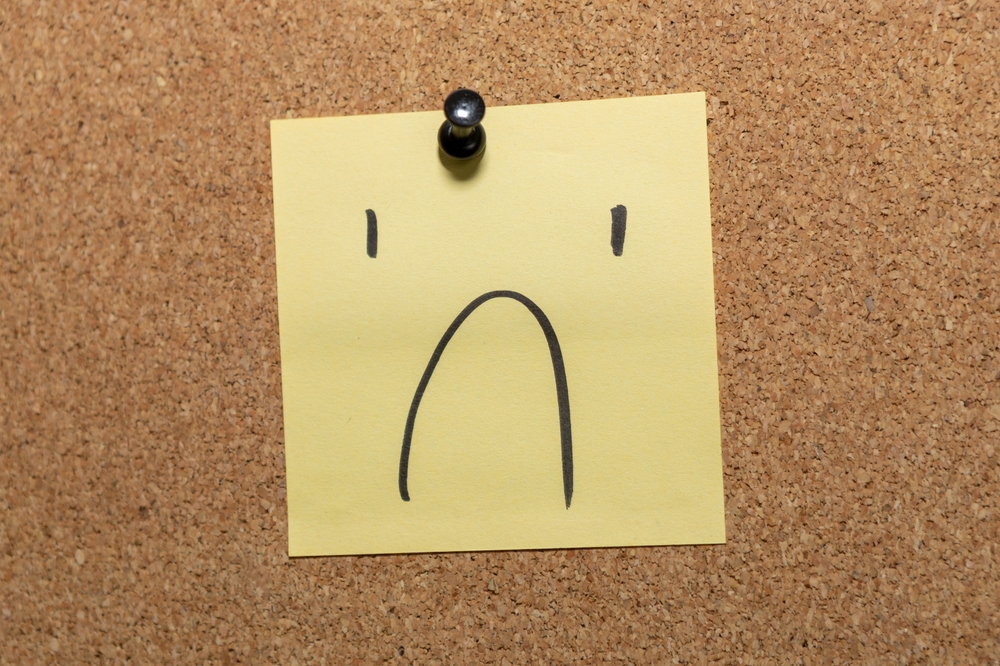 post it note with a frown