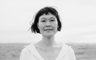a black and white head and shoulders portrait picture of artist Yumi Umiumare.