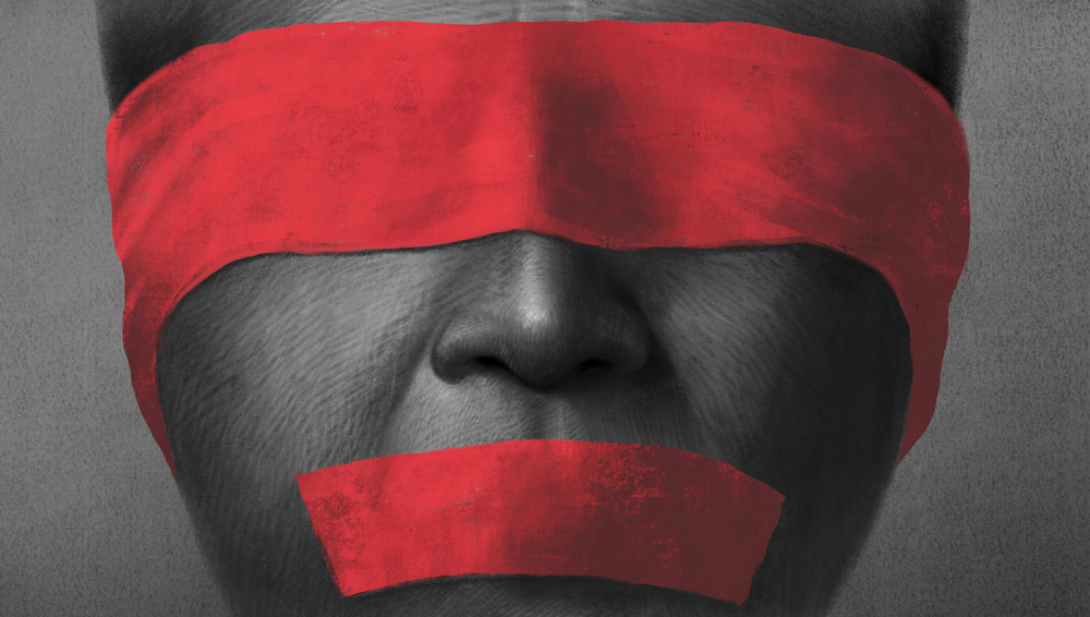 Detail of face with red tape censoring voice and sight
