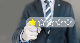 Bad review. Image is of a man's torso, wearing a suit and stripey tie and pointing out à la Lord Kitchener. His finger is touching a yellow star, the only one filled in a row of five.