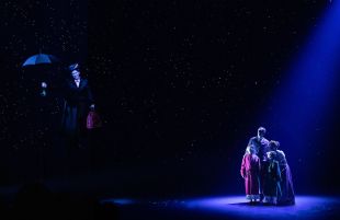 A scene from the stage musical 'Mary Poppins', showing the titular character flying away with her umbrella, as the Banks family look on from the stage.