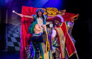 Three people in Shakespearean costume. On is leaning down about to drink from a bottle in a production of Sh!t-faced Shakespeare.